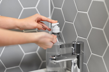 Image showing close up of woman washing hands with liquid soap