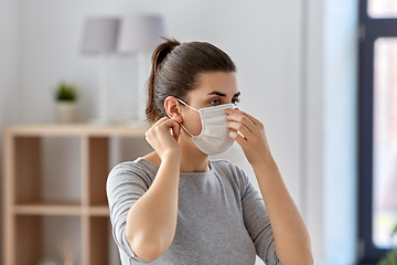 Image showing young woman wearing protective medical mask