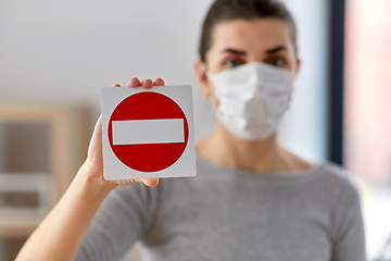 Image showing woman in protective medical mask showing stop sign