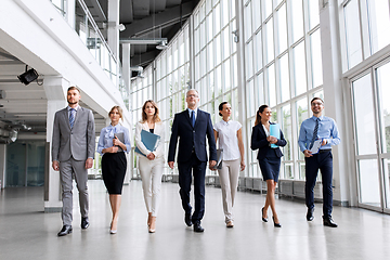 Image showing business people walking along office building