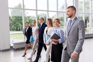 Image showing business people walking along office building