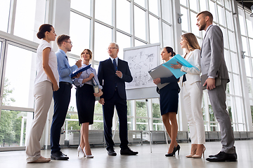 Image showing business team with scheme on flip chart at office