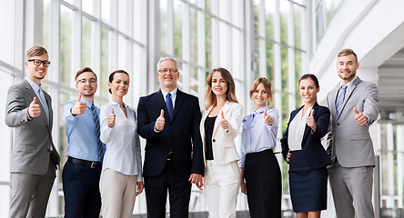 Image showing business people showing thumbs up at office