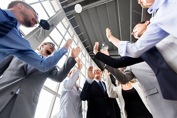 Image showing business people making high five at office