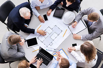 Image showing architects with laptop and blueprint at office