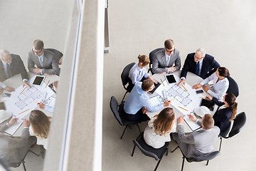 Image showing architects with laptop and blueprint at office