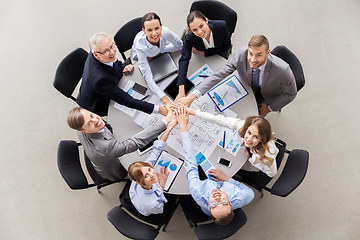 Image showing happy business people stacking hands