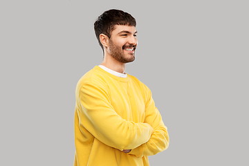 Image showing young man in yellow sweatshirt with crossed arms