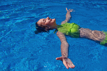 Image showing teen girl relaxing near swimming pool