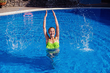 Image showing teen girl relaxing near swimming pool