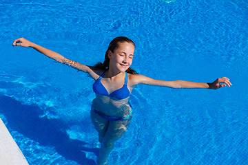 Image showing teen girl relaxing near swimming pool