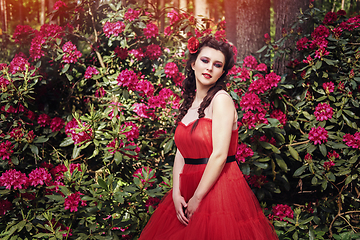 Image showing girl in dress in rhododendron garden