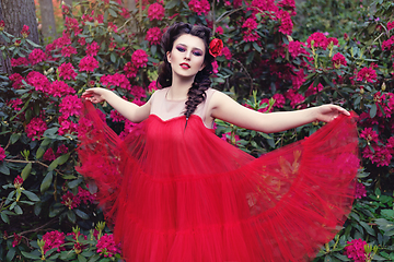 Image showing girl in dress in rhododendron garden