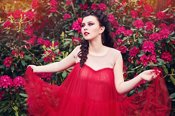 Image showing girl in dress in rhododendron garden