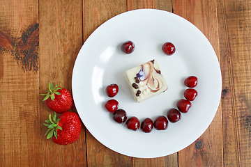 Image showing strawberry cherry with cake in shape of smile