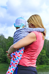 Image showing mother holds her daughter