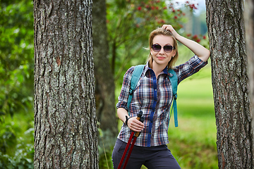 Image showing young woman with nordic walk pols