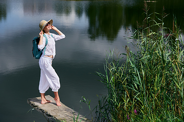 Image showing Young woman resting near lake