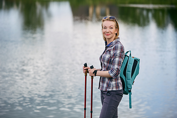 Image showing young woman with nordic walk pols