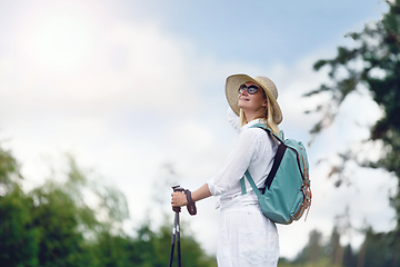 Image showing young woman with nordic walk pols