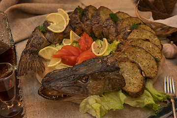 Image showing Stuffed pike with vegetables and greens.