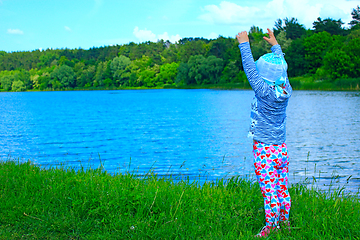 Image showing baby is happy near the river