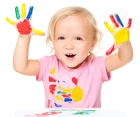 Image showing Portrait of a cute little girl playing with paints