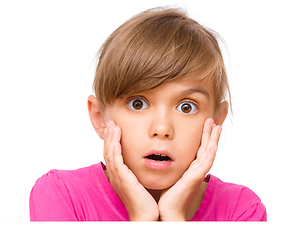 Image showing Little girl is looking out from the blank banner