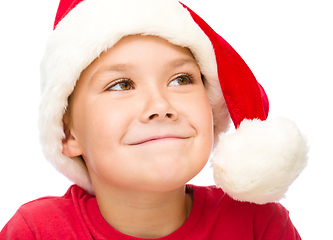 Image showing Little girl in santa hat is daydreaming