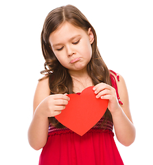 Image showing Portrait of a sad little girl in red