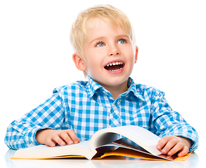 Image showing Little child play with book