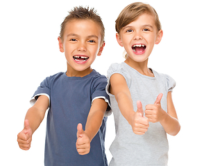 Image showing Little boy and girl are showing thumb up sign