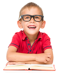 Image showing Little boy is reading a book