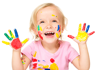 Image showing Portrait of a cute little girl playing with paints