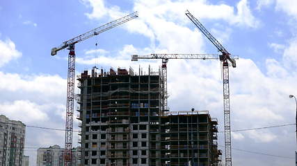 Image showing Tower cranes against blue sky, with clouds. Timelapse. UltraHD stock footage