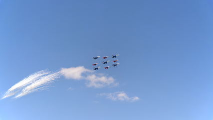 Image showing Fighters Su-35 (Flanker-E) and MiG-29 (Fulcrum) lined diamond fly with fireworks fly in sky