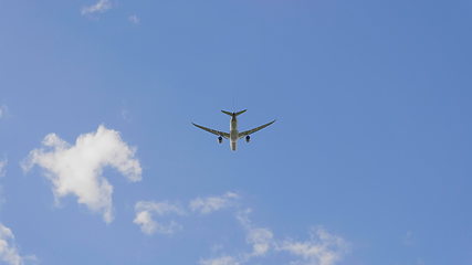 Image showing Commercial passenger airplane flying overhead on sunny day. UltraHD stock footage