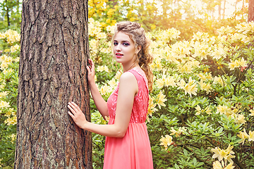 Image showing girl in dress in rhododendron garden