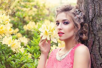 Image showing girl in dress in rhododendron garden