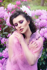 Image showing girl in dress in rhododendron garden