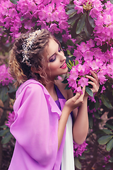 Image showing girl in dress in rhododendron garden