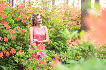 Image showing girl in dress in rhododendron garden