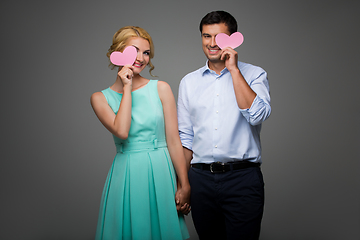 Image showing Beautiful couple holding pink hearts