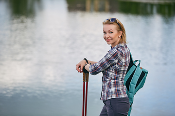 Image showing young woman with nordic walk pols