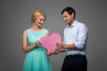 Image showing Beautiful couple holding pink broken heart