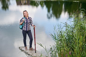 Image showing young woman with nordic walk pols