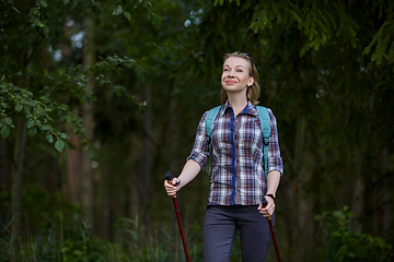 Image showing young woman with nordic walk pols