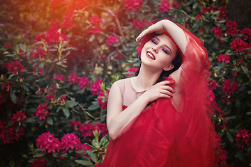 Image showing girl in dress in rhododendron garden