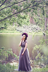 Image showing girl in dress in rhododendron garden