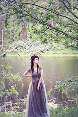 Image showing girl in dress in rhododendron garden